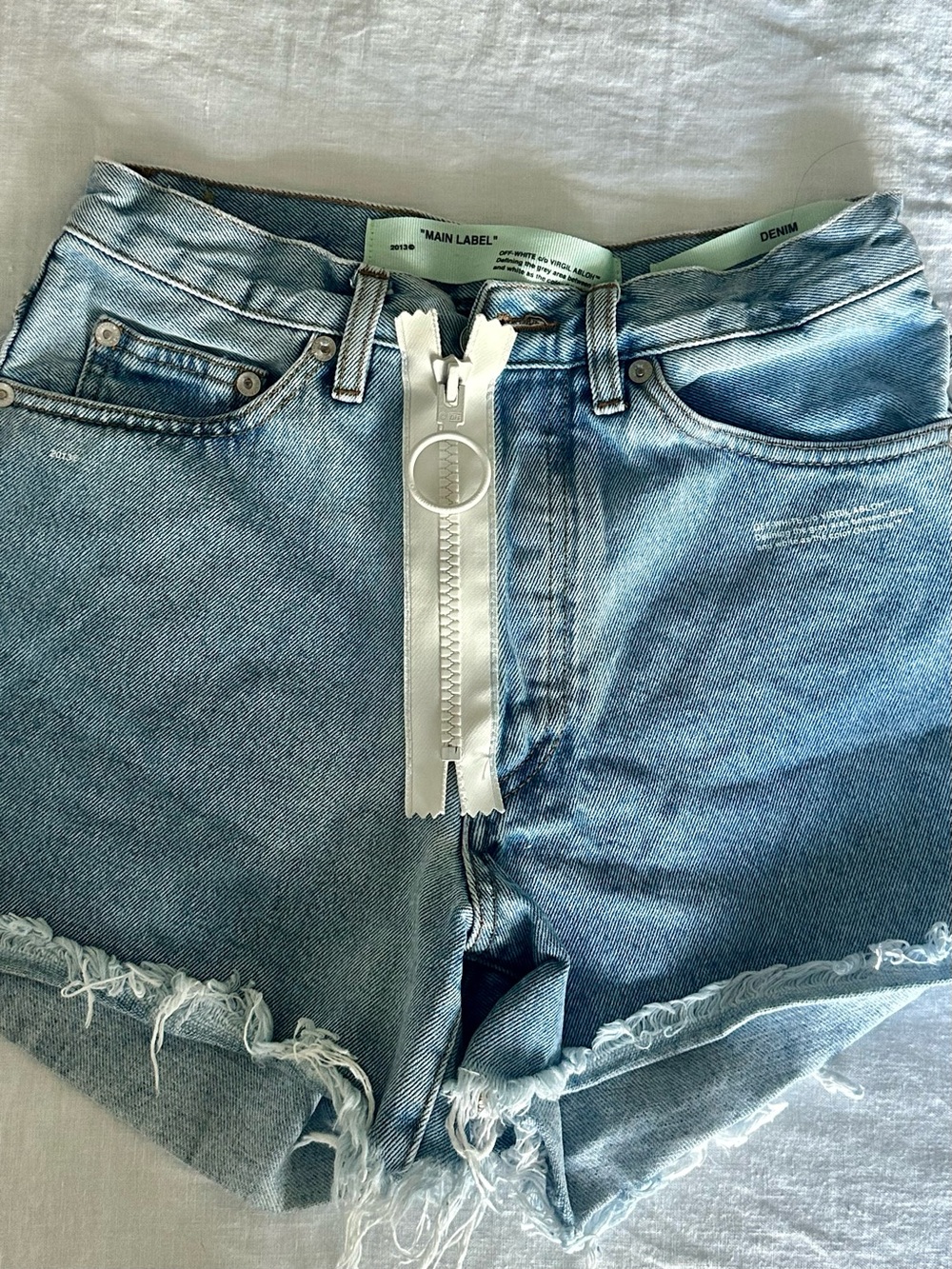 Off-White Light Blue Denim Cutoff Shorts with White Ring Zip